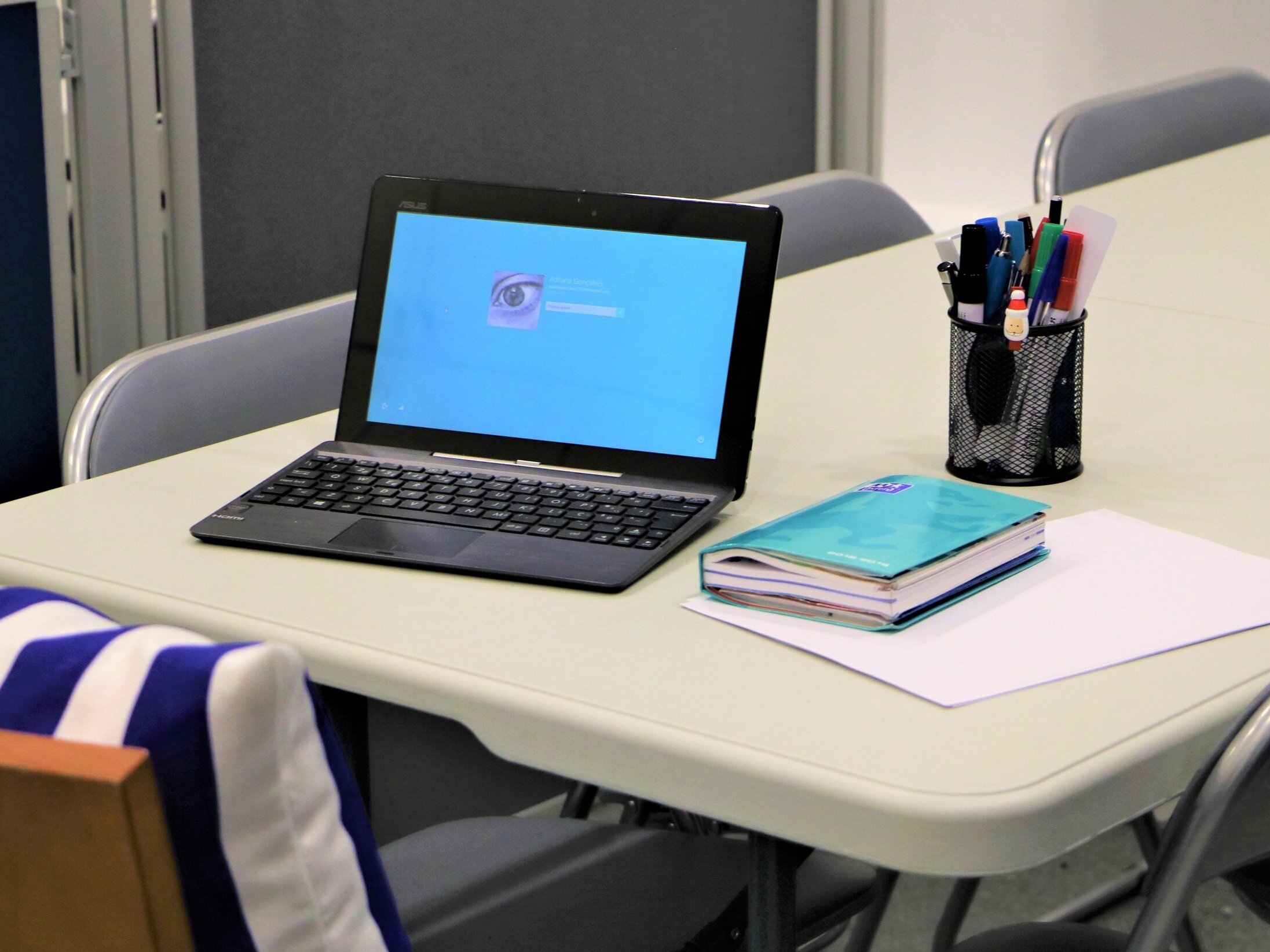 Secretária de estudo com computador portátil e material de apoio